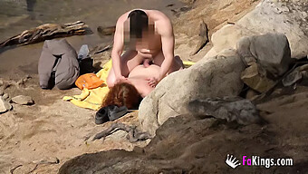 A Redheaded Girl Receives A Shower Of Cum At The Beach